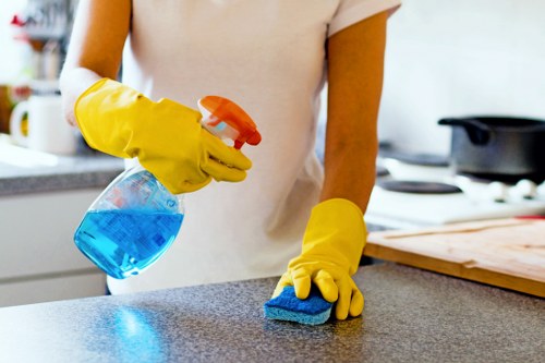 Cleaning technician using safe carpet cleaning equipment in a controlled workspace